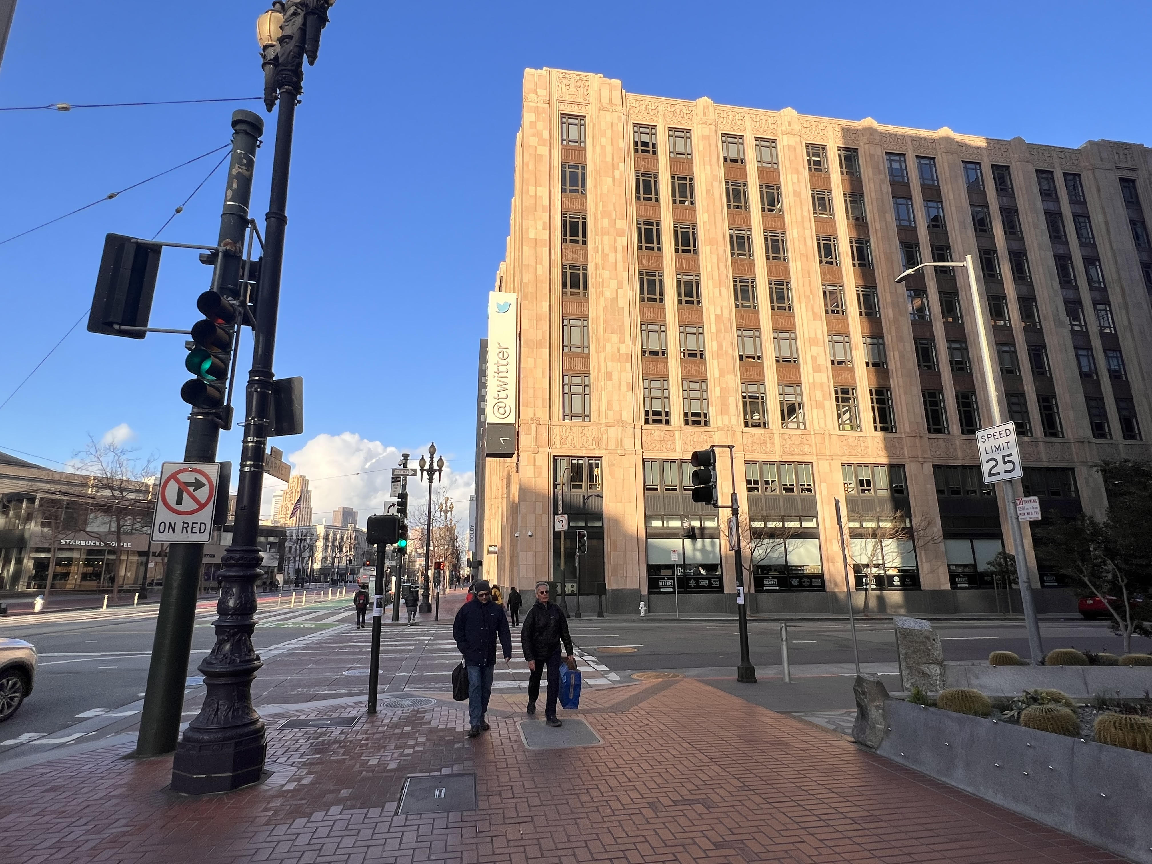 A view of Twitter HQ as owned by Elon Musk. The setting March sun bathes the building.